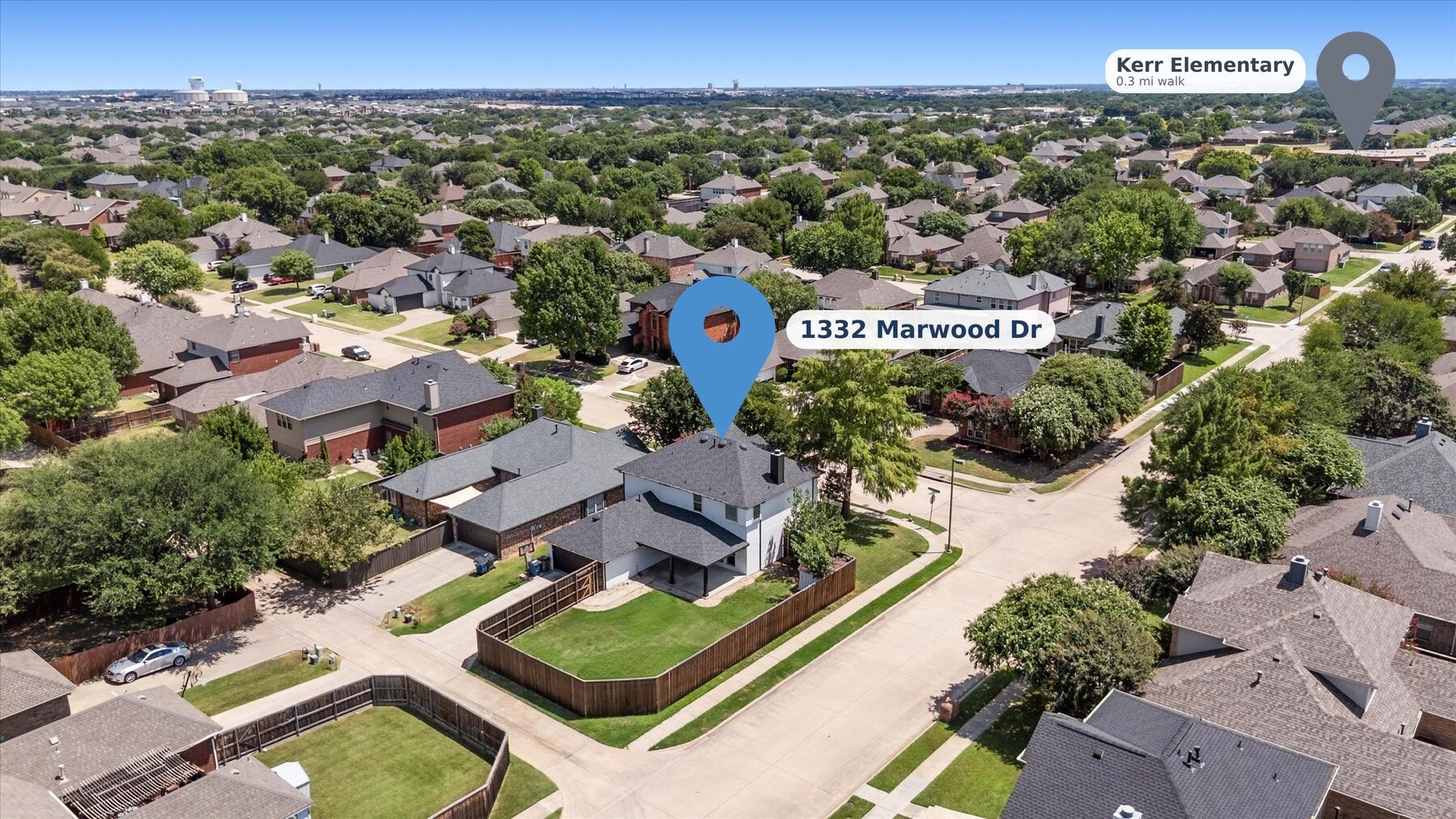 Aerial view of the home on its corner lot with Kerr Elementary marked 0.3 miles away